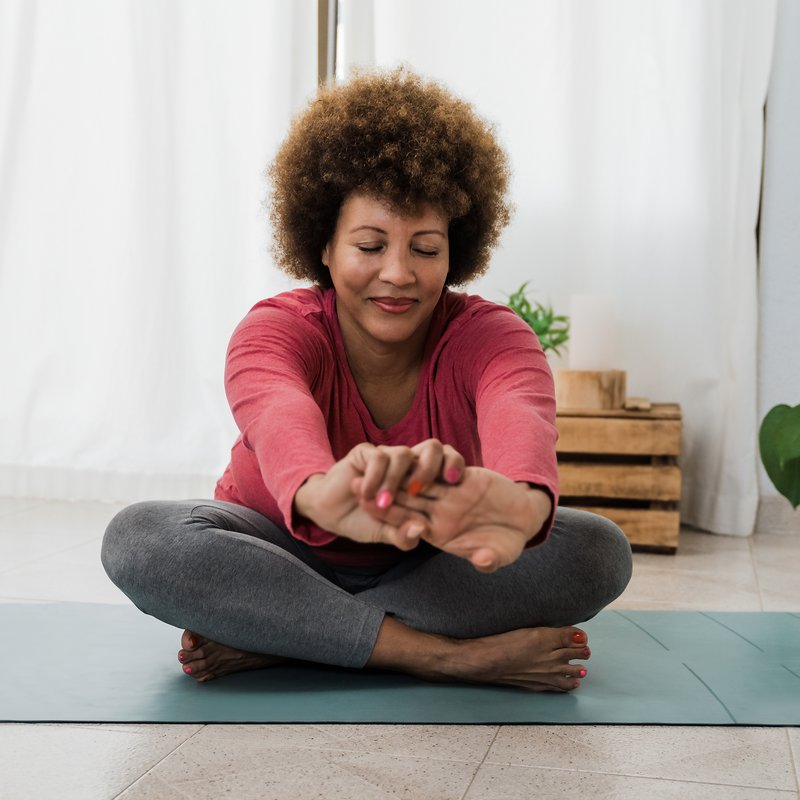 Woman stretching forward during a quiet at-home practice