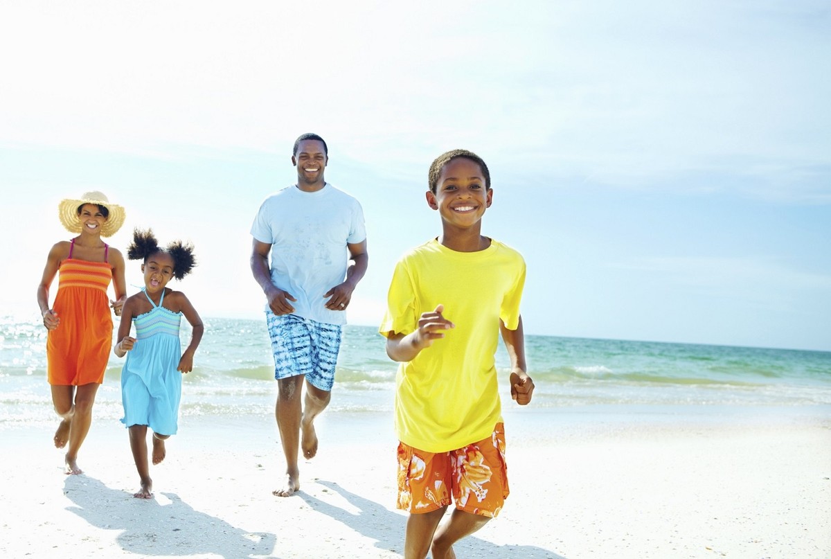 A family running together on the beach